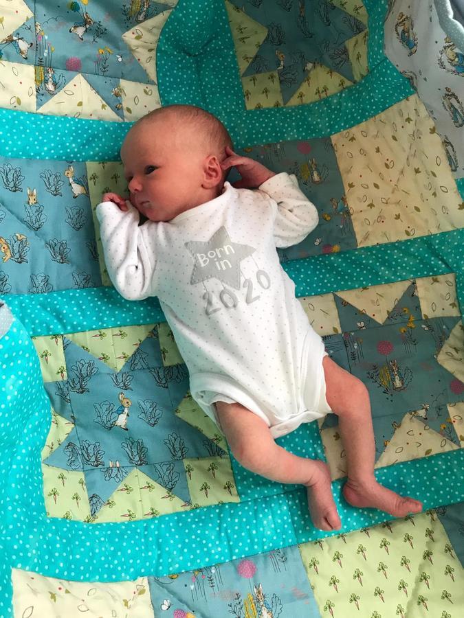 Oliver George on Peter Rabbit quilt made by Ann